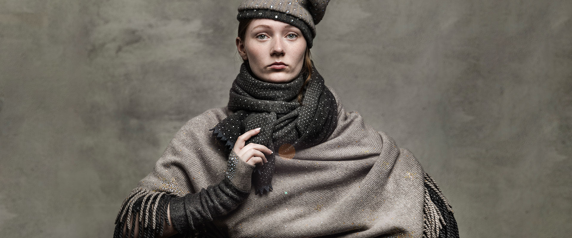 Model wearing crystal embellished scarf and other luxury fashion wear by Elyse Allen Textiles.