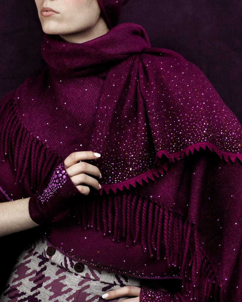 Model wearing cashmere Bordeaux colored shawl with sawtooth fringe and Swarovski crystal embellishments. 