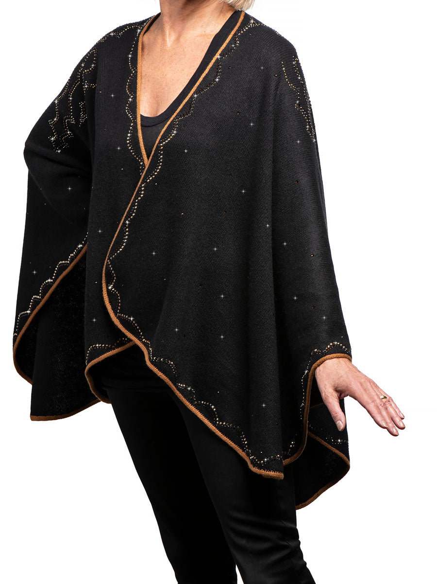 Handmade cashmere Cropped Western Ruana Cape shown in black. Ruana Cape is embellished with a Western pattern along the border with Swarovski crystals and metal rhinestones.Swarovski