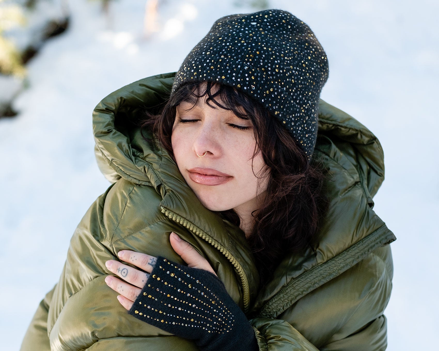 Model wearing Elyse Allen Textiles' dark green Epaulette Fingerless Gloves. editorial-image