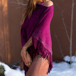 Model wearing a knitted cashmere Lattice Poncho in the color Bordeaux. editorial-image