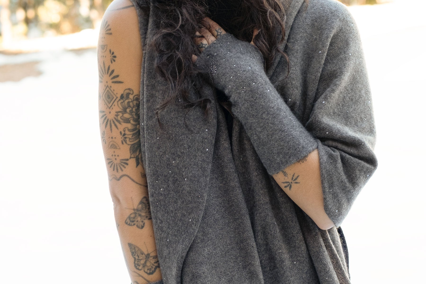 Model standing outside in the cold wearing a grey cashmere shawl. Scarf is made of luxury cashmere and embellished with Swarovski crystals. editorial-image