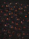 Black cashmere fabric swatch embellished with red crystals.