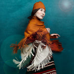 Model twirling and showcasing Saffron and Ivory colored Estrella Ponchos, by Elyse Allen Textiles. editorial-image.