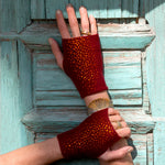 Models hands showing rust colored Cropped Hydra Gloves against a turquoise colored door. editorial-image
