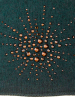 Dark Green Sea Urchin Cloche fabric swatch with amber colored Swarovski crystals.